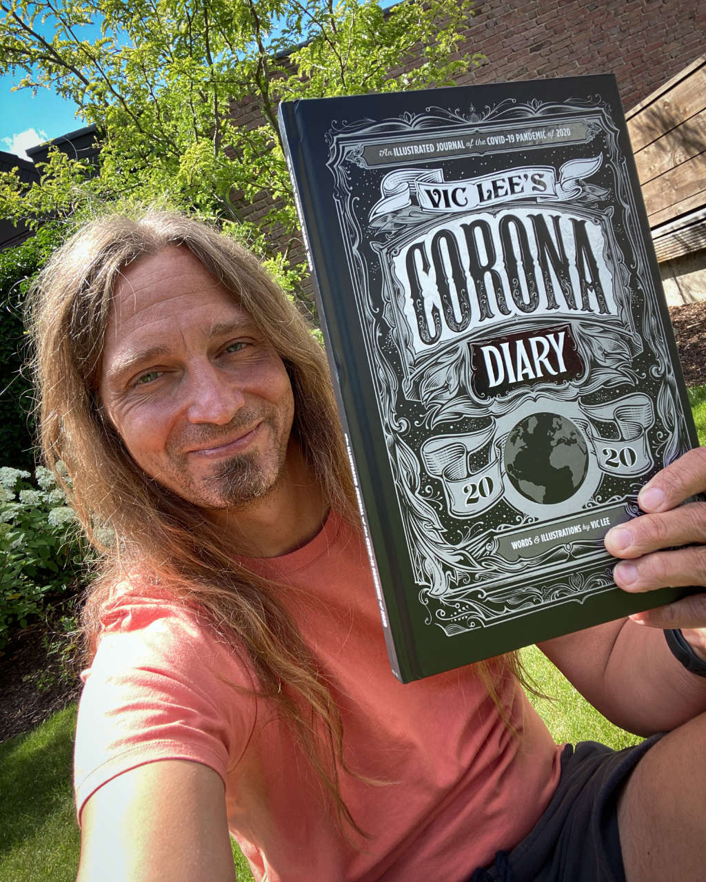 The photo showing me holding up the Corona Diary 2020 by Vic Lee, a book full of illustrations by him.