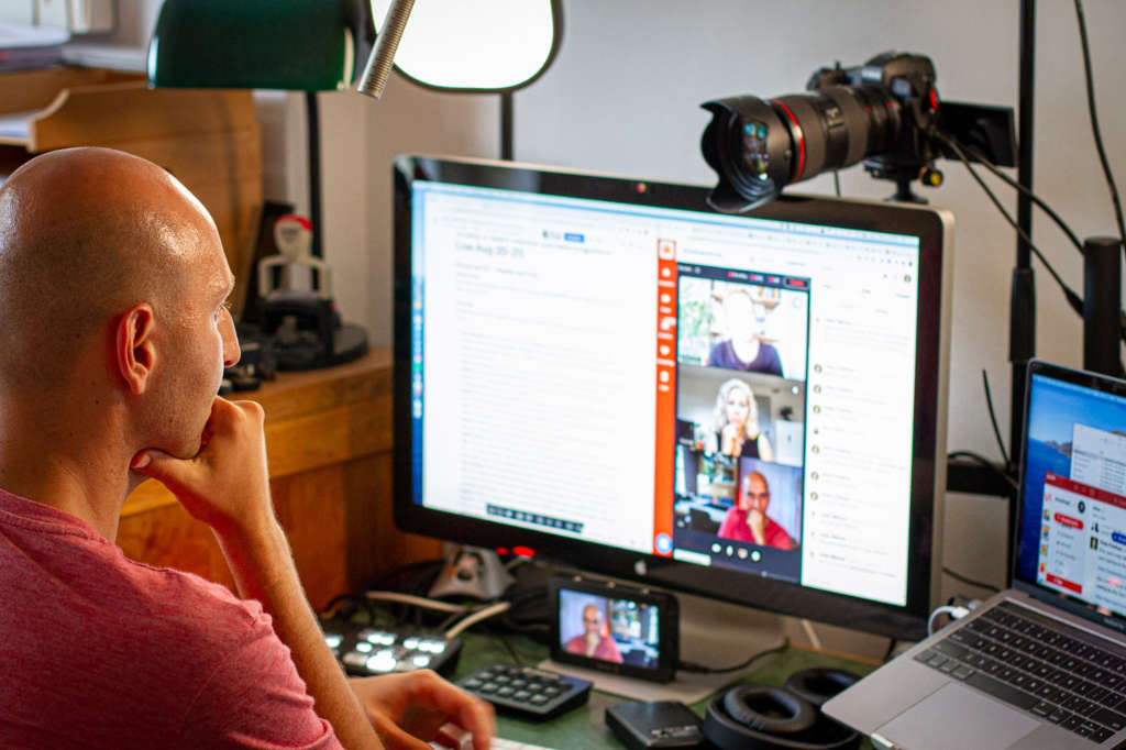 Photo showing Vitaly Friedman sitting in front of his computer, running SmashingConf as online event