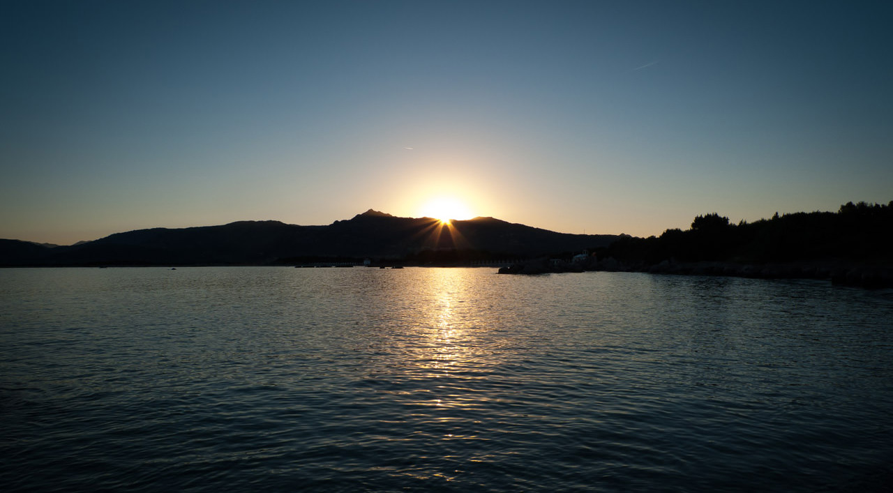 The sun going down behind a mountain in Sardinia